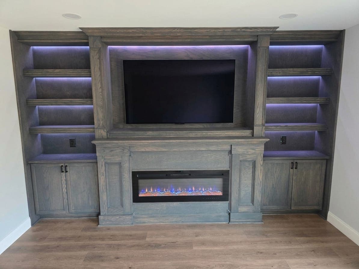 Custom built-in entertainment wall with fireplace by Elite Finishes