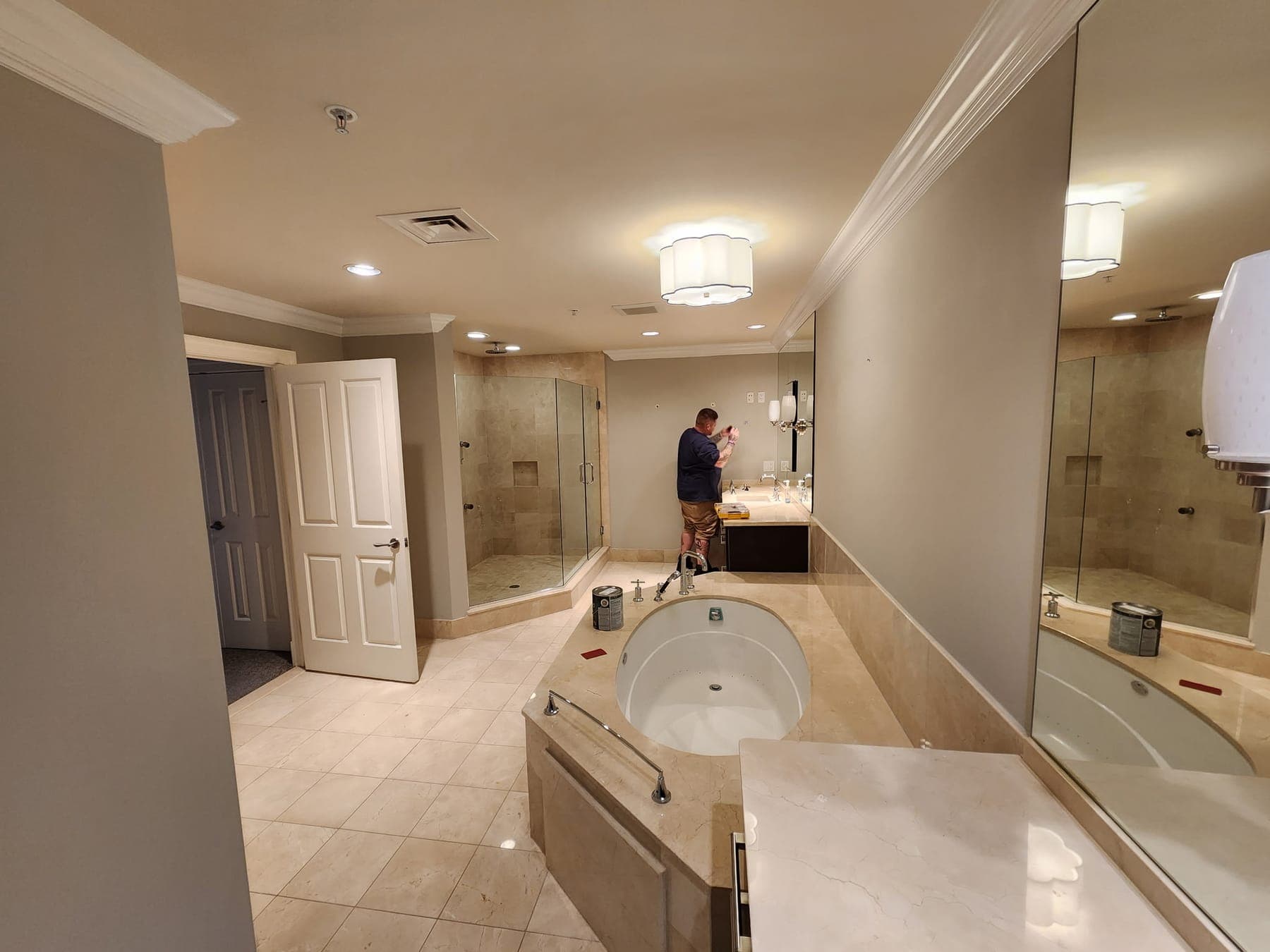 Elite Finishes crew finishing a gray tiled primary bathroom in a Baltimore area home